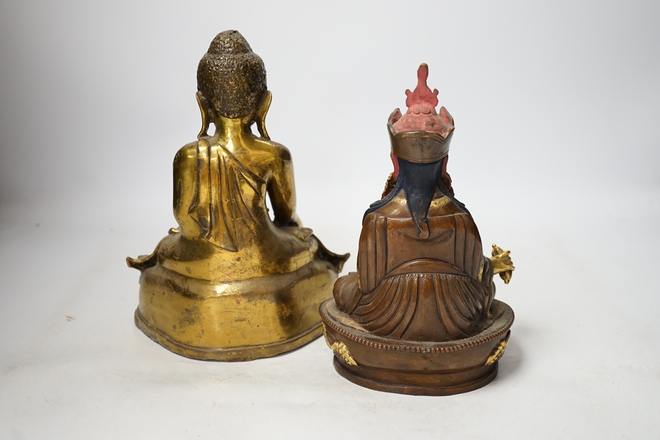 A Burmese bronze Buddha and a Nepalese bronze figure of Guru padmasambhava, tallest 23cm high. Condition - good